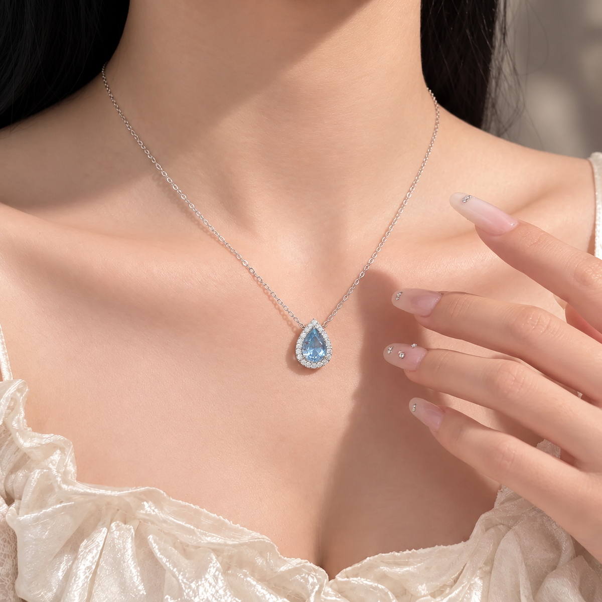Azure Teardrop Necklace worn with an ivory neckline