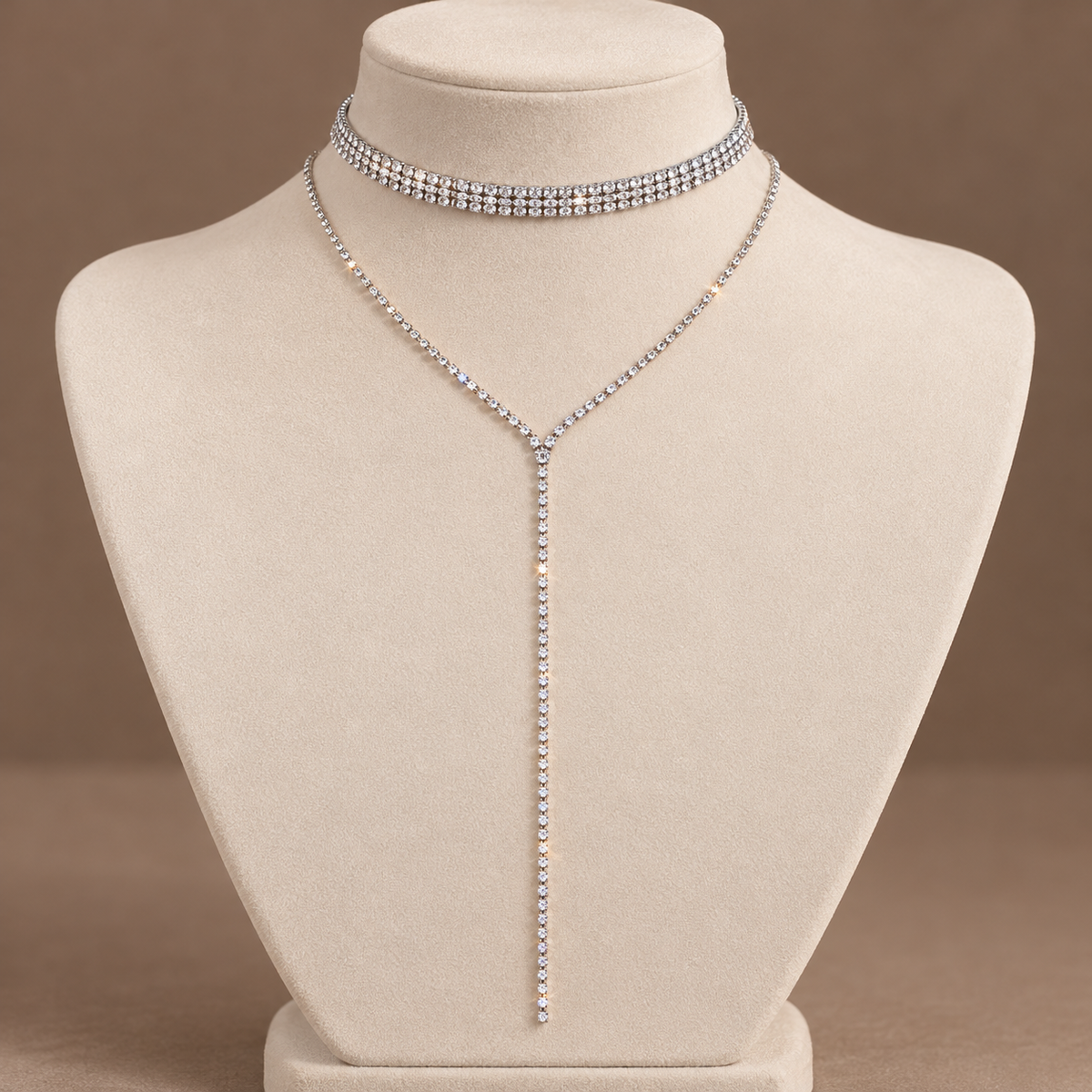 Midnight Muse Narrow choker and long Y necklace on an ivory jewelry display, illustrative styled image